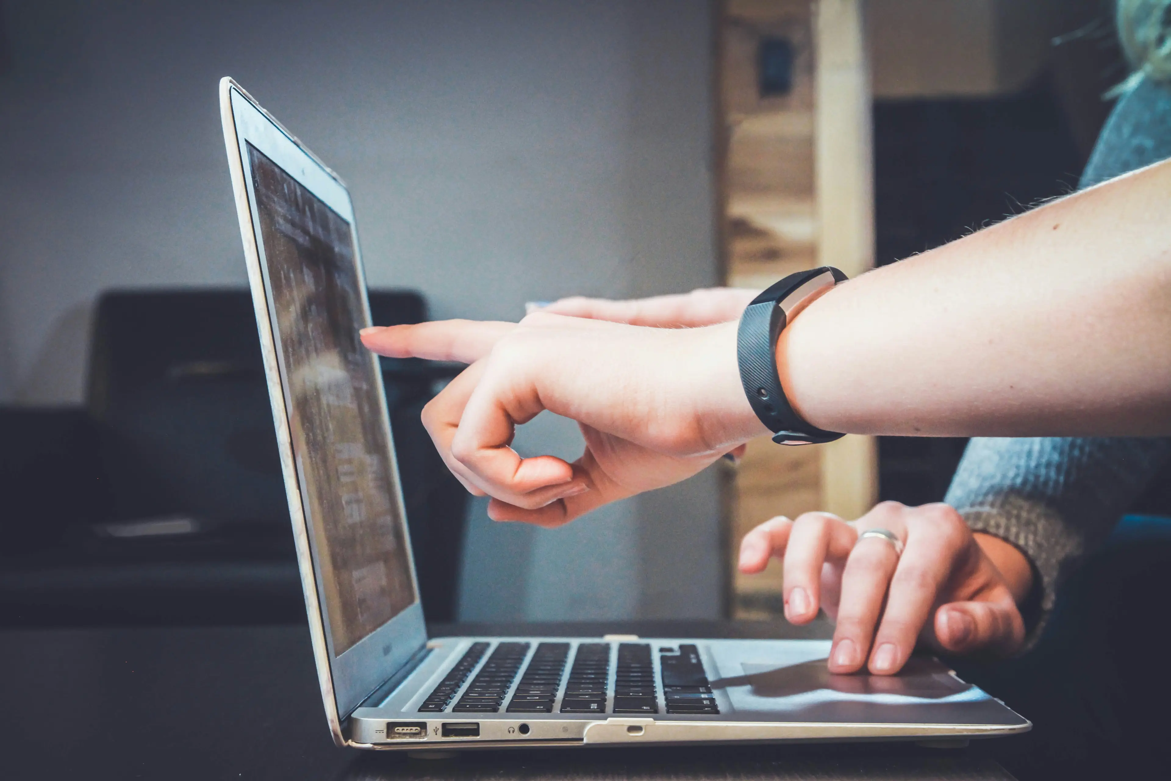 Image of a man touching a macbook